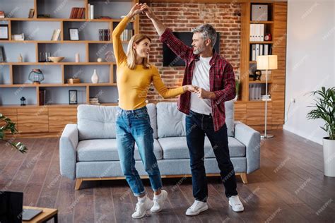 Premium Photo Smiling Middle Aged Caucasian Husband And Wife Dancing Have Fun And Enjoy Free