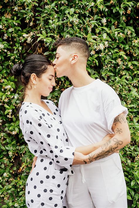 Portrait Of Young Lesbian Couple Standing Outdoors Embracing And