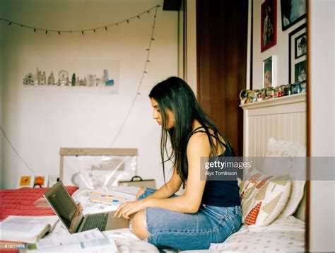 Profile Shot Of Teenage Girl In Her Bedroom Working On Laptop Photo