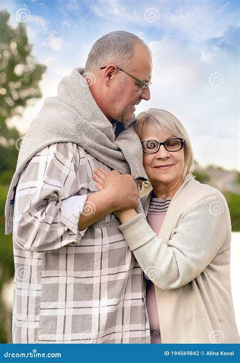 Old Age Relationships And People Concept Happy Senior Couple Hugging In Nature The Husband