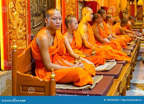 Buddhist Monks Sit In A Temple In Orange Robes Editorial Photography
