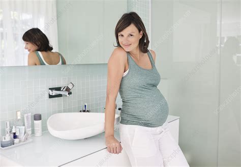 Pregnant Woman Leaning On Bathroom Sink Stock Image F0138219