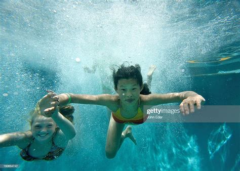 Two Girls Swimming Underwater In A Pool High Res Stock Photo Getty Images