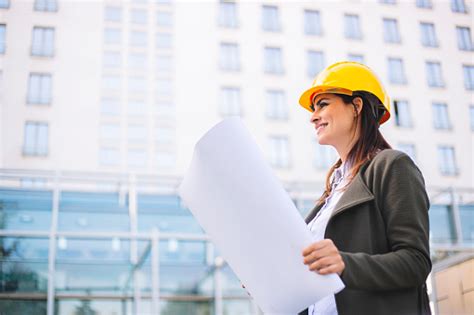 Young Female Architect Reviewing Building Plan Stock Photo Download