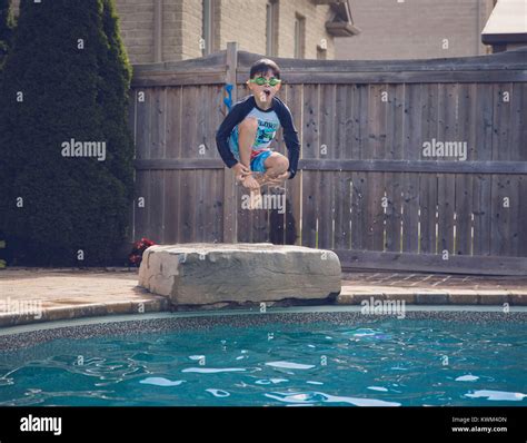 Boy Jumping Into Swimming Pool Hi Res Stock Photography And Images Alamy