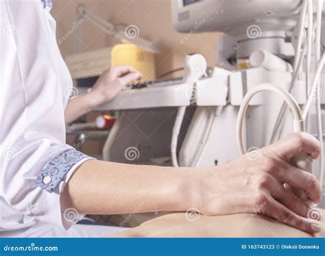 An Ultrasound Doctor Examines The Neck And Abdomen In A Child Using An
