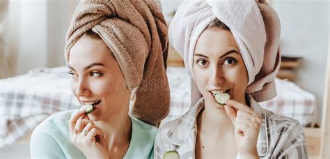 two girls make homemade face and hair beauty masks cucumbers for the freshness of the skin