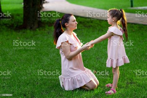 Mother And Daughter 56 Years Old Walking In The Park In The Summer Daughter And Mother Laughing