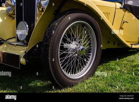 Classic antique car in cream white color on the outdoor grass, the