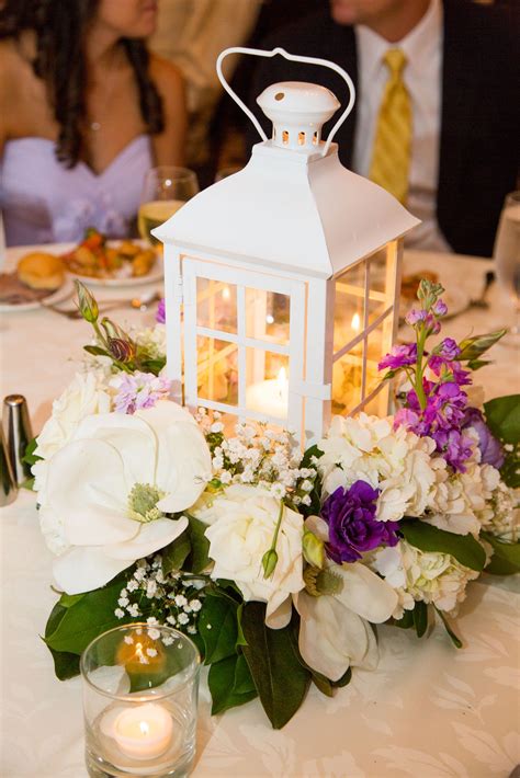 Wedding Reception Table Decor White Lantern Surrounded By Flowers And