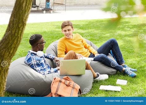 Two Students Relaxing Outdoors On Campus Stock Photo Image Of Break