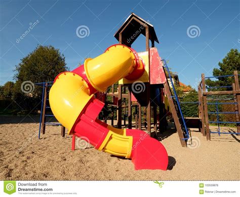 Playground Colorful Tube Slide In Public Park New Slider Tube And Wooden Ladders Stock Photo