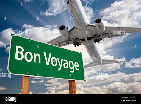 Bon Voyage Green Road Sign and Airplane Above with Dramatic Blue Sky ...
