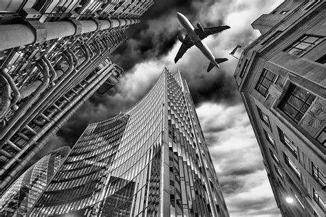 A Jet Plane Flying Over The City Photograph By Bombaert Patrick Fine