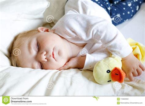 Cute Adorable Baby Girl Of 6 Months Sleeping Peaceful In Bed Stock