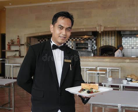 Asian Chinese Room Service Waiter Serving Food In Hotel Stock Photo