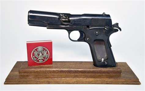 Flak Damaged M1911 45 Cal Pistol And Cap Badge National Museum Of