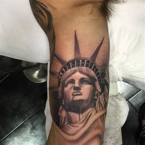 Love Your Tattoo Black Ink Statue Of Liberty Face Tattoo On Bicep