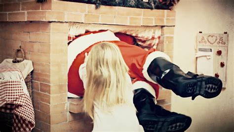 A Cute Little Girl Helps Santa Claus Going Through The Chimney Because