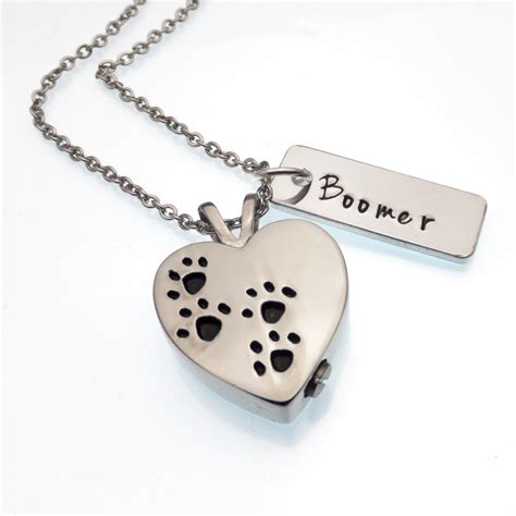 Pet ashes jewelry is created with a small compartment that allows for a portion of ashes or personal mementos (lock of fur, whisker, claw) to be stored, creating a handheld memorial of your precious pet. Heart Pet Urn Necklace Cremation Jewelry Paw Print