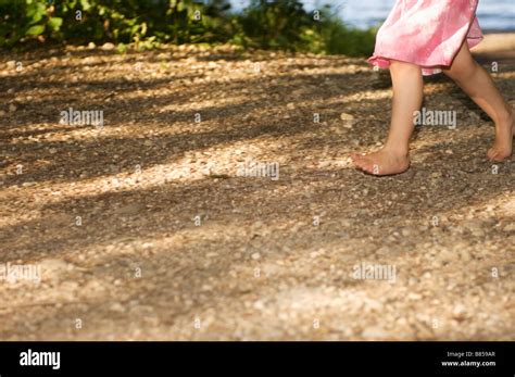 Detail Of Little Girl Walking Barefoot Through Forest Stock Photo Alamy