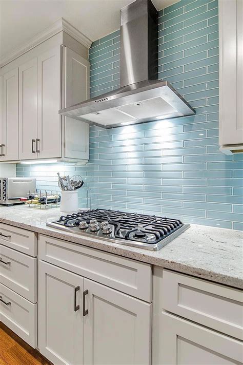 The Reflective Quality Of This Kitchen S Blue Glass Tile Backsplash Is A Perfect Blue Glass