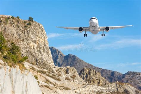 Mountain Landscape And Landing Passenger Aircraft Travel To The