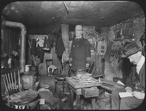 file two officials of the new york city tenement house department inspect a cluttered basement