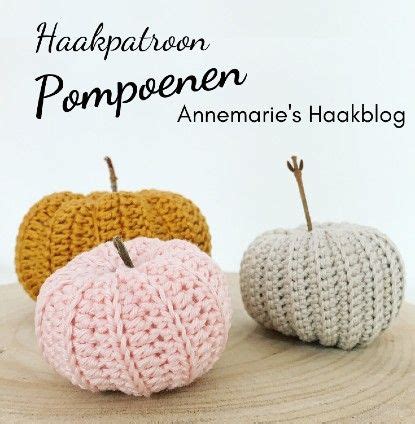 Three Knitted Apples Sitting On Top Of A Wooden Table