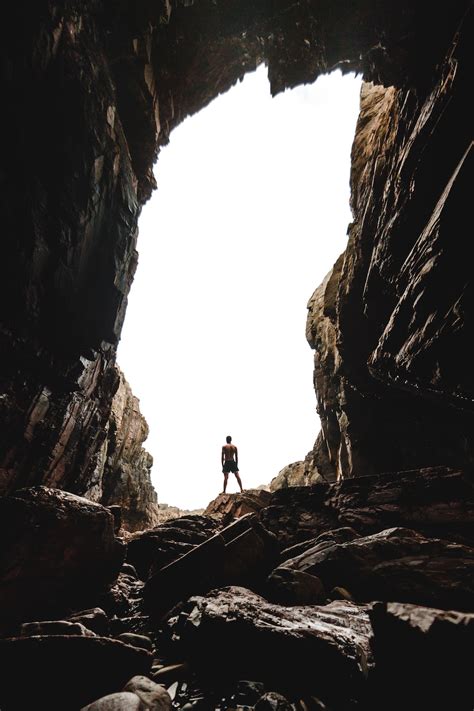 Man Standing On Cave Photo Free Nature Image On Unsplash
