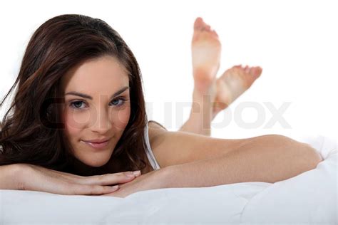 beautiful woman lying in her bed stock image colourbox