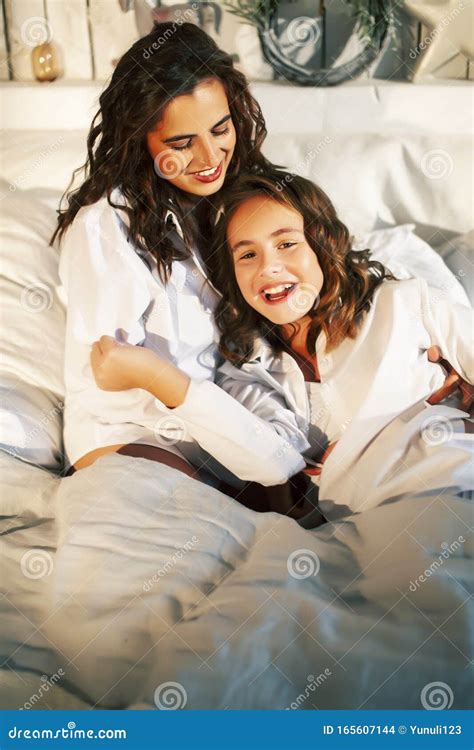 Young Mother With Daughter In Bed Huggings Lifestyle People At Home