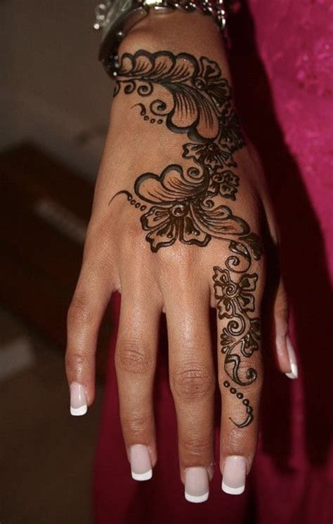 A Womans Hand With Henna Tattoos On It