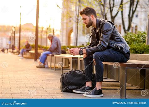 Young Man Sitting On A Bench Stock Photo Image Of Break Casual 96354342