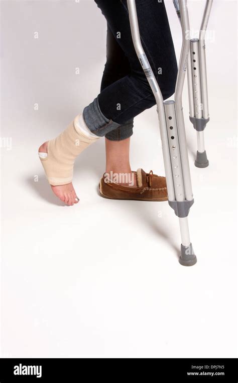 A Girl With An Injured Foot On Crutches Stock Photo Alamy