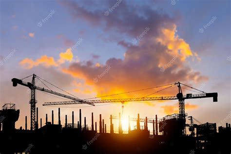 Premium Photo Silhouettes Of Building Construction Site And Construction Cranes With Sunset