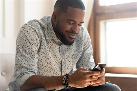 Smiling African American Man Feel Happy Texting On Smartphone Totalmd