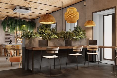 An Office With Plants On The Desks And Hanging Lights Above It Along
