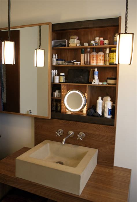 Round frameless surface mount medicine cabinet with matching sink. Is this a sliding mirror/cabinet door?