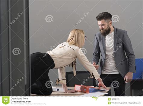Business Woman Seduce Boss In Office Business Woman On Desktop Look At Bearded Businessman