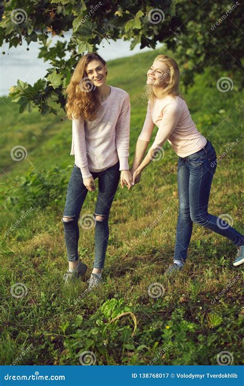 Two Young Girls Hold Hands Stock Image Image Of Park 138768017