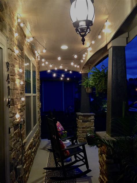 A small front porch gets a modern makeover with boho macrame swings. String Lights on the Front Porch - Life Love Larson