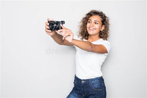 Portrait Of A Smiling Young Latin Woman Taking Selfie With Photo Camera Over Gray Background
