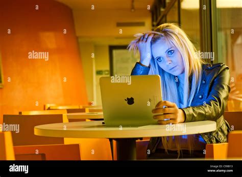 A 16 Year Old Blonde Haired Slim Teenage Girl Using An Apple Ipad