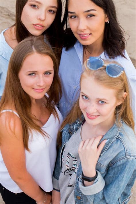 Close Up Portrait Of Four Young Beautiful Girlfriends In Summer On The