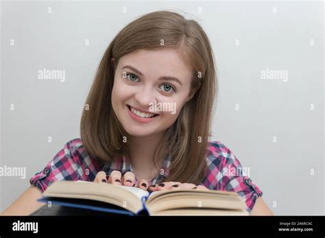 Smiling Young Caucasian Girl Woman Reading A Book Stock Photo Alamy