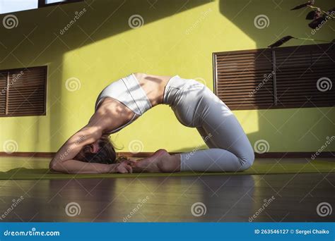 Young Woman Leading A Healthy Lifestyle And Practicing Yoga Performs