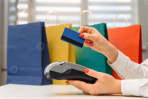 Close up of hand using credit card swiping machine to pay. credit card
