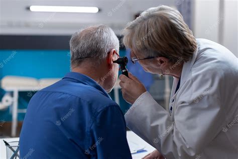 Free Photo Physician Holding Otoscope To Do Ear Consultation For