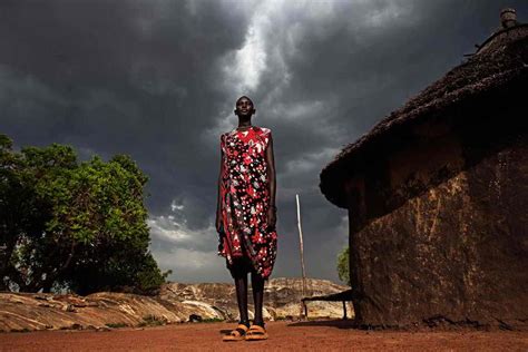 Scenes From Sudan Dinka Woman Stands Outside Her Home As A Storm
